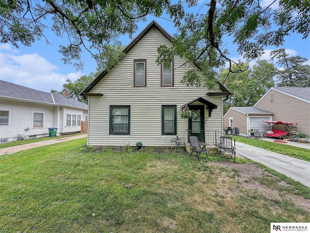 view of front of property with an outdoor structure, a garage, and a front lawn