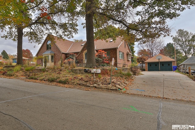 view of front of property featuring a garage and an outdoor structure