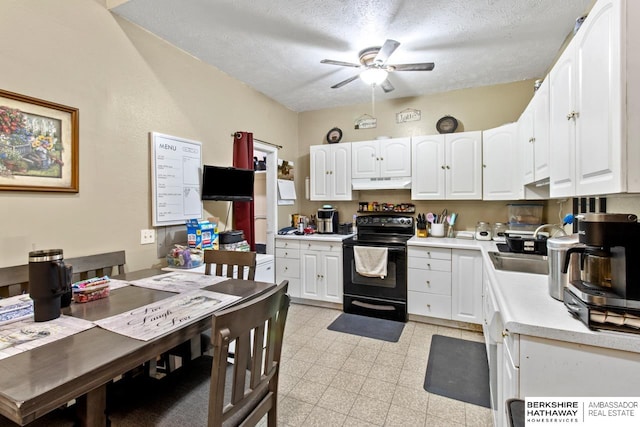 kitchen with sink, a textured ceiling, electric range, ceiling fan, and white cabinets