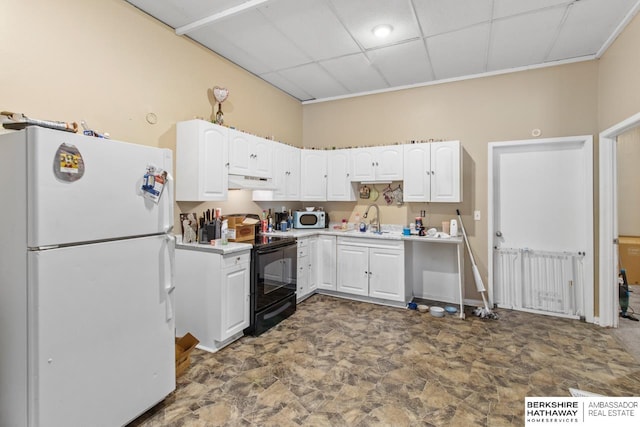 kitchen with sink, white cabinetry, a paneled ceiling, and white appliances