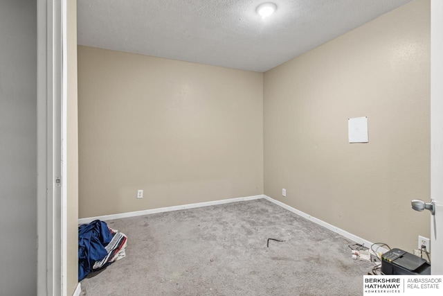 unfurnished room featuring a textured ceiling and carpet floors