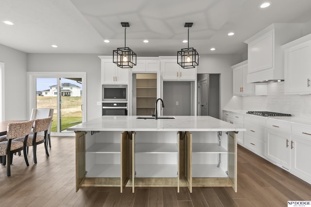 kitchen with tasteful backsplash, gas cooktop, built in microwave, stainless steel oven, and a sink