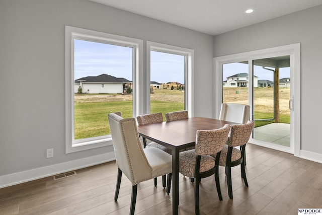 dining space with visible vents, baseboards, recessed lighting, and wood finished floors