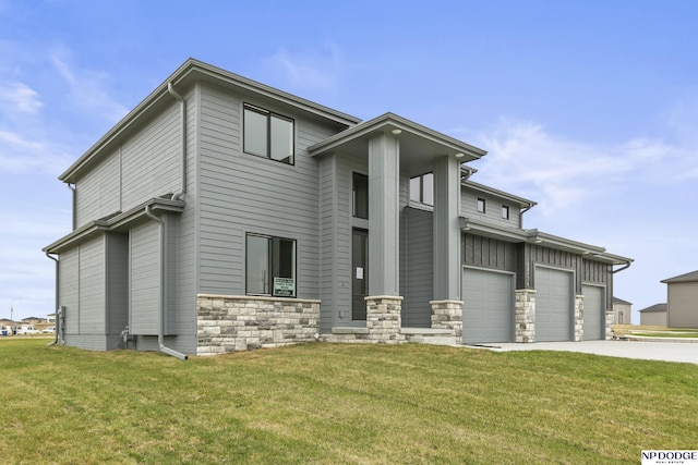 view of front facade featuring driveway, stone siding, and a front lawn