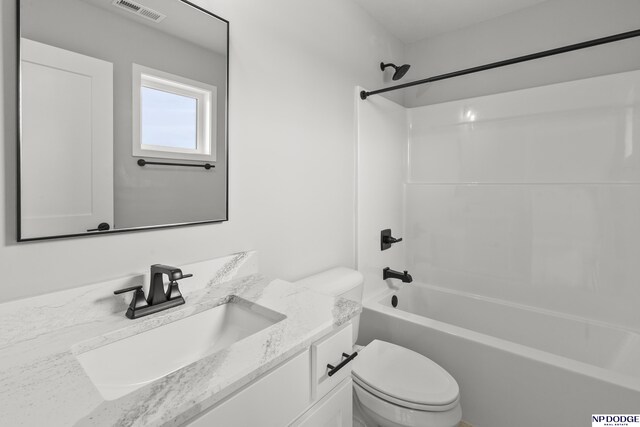 bathroom with visible vents, toilet, vanity, and bathing tub / shower combination