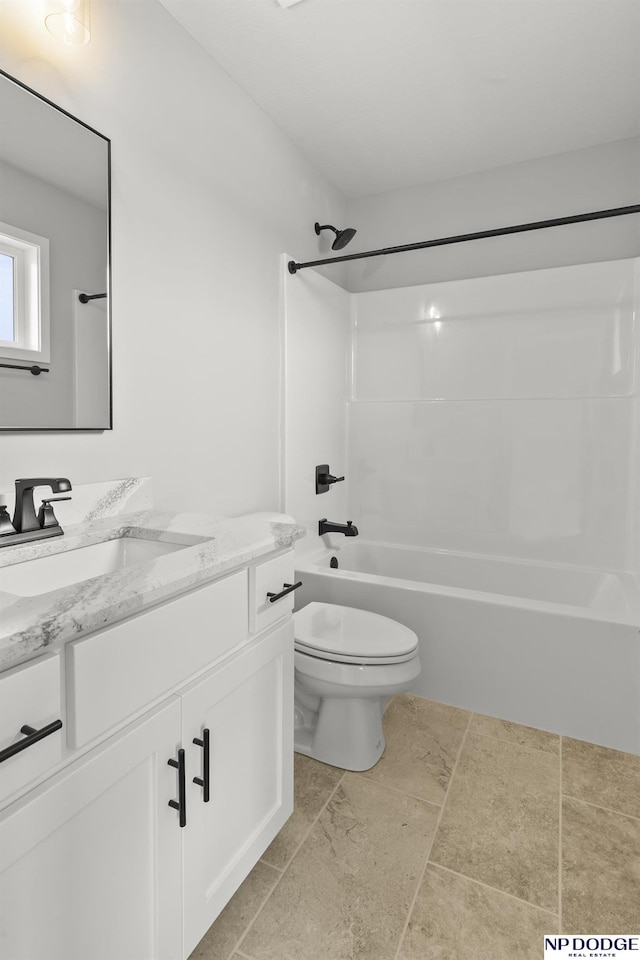 bathroom featuring vanity, toilet, and tub / shower combination