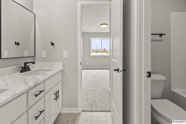 full bath with tile patterned flooring, toilet, vanity, and baseboards