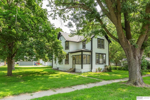 view of front of house featuring a garage and a front lawn