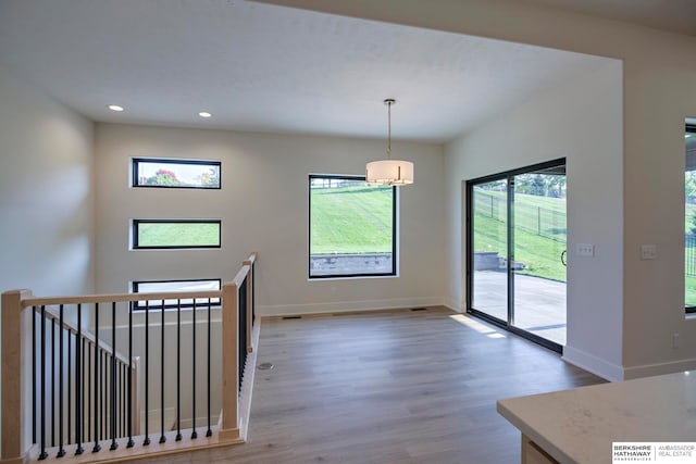 interior space featuring a notable chandelier and wood-type flooring