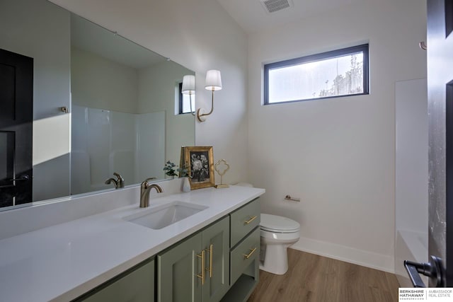 full bathroom featuring vanity, shower / washtub combination, wood-type flooring, and toilet