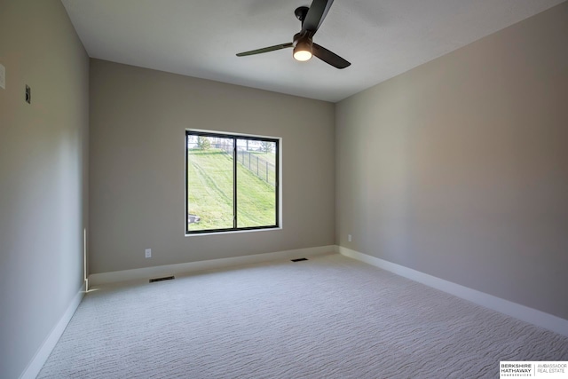 carpeted spare room with ceiling fan