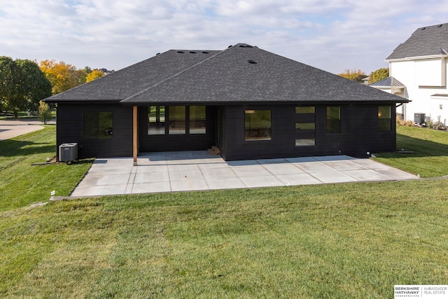 back of property featuring a patio, central AC, and a lawn