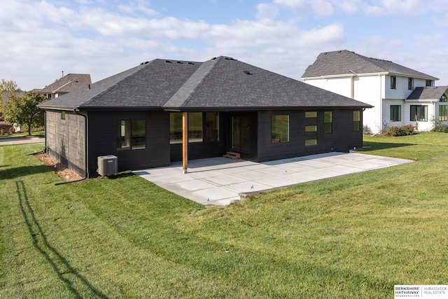 rear view of house featuring a patio, a lawn, and central AC unit