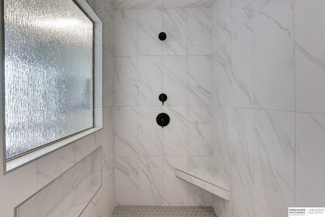 bathroom with a tile shower