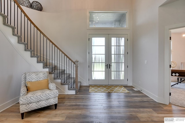 entryway with french doors and wood-type flooring