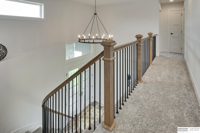 stairs featuring carpet and an inviting chandelier