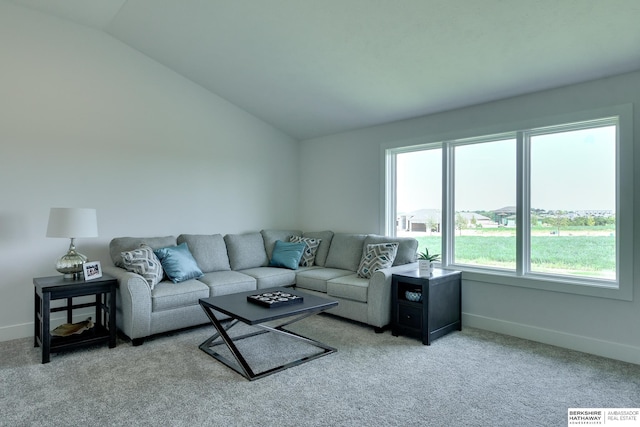 carpeted living room with lofted ceiling