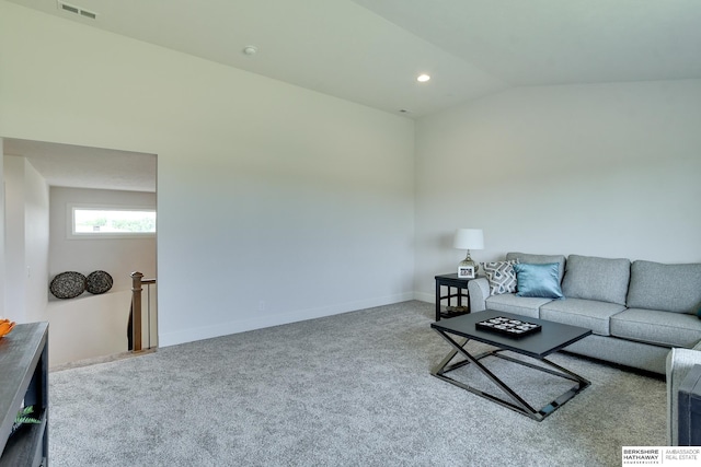 carpeted living room featuring vaulted ceiling