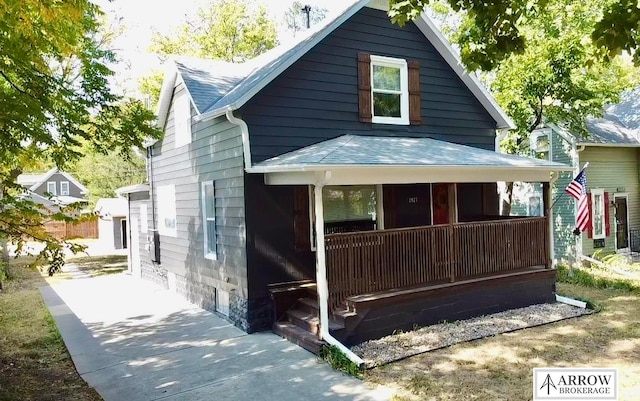 rear view of property featuring a porch