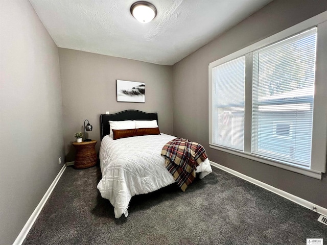 carpeted bedroom featuring a textured ceiling