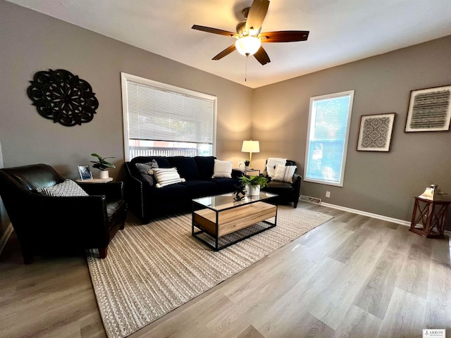 living room with hardwood / wood-style floors and ceiling fan