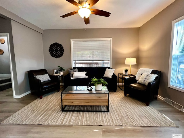 living room with hardwood / wood-style flooring and ceiling fan