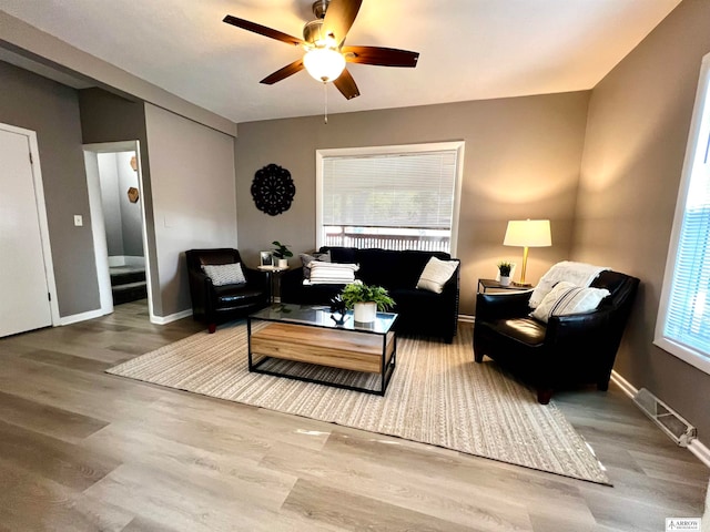 living room with ceiling fan, a healthy amount of sunlight, and wood-type flooring