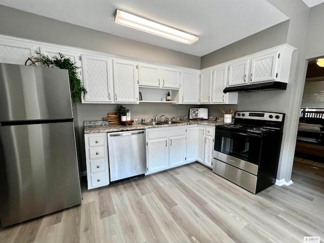 kitchen with light hardwood / wood-style flooring, stainless steel appliances, sink, white cabinets, and light stone counters