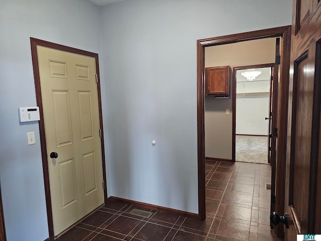 corridor with dark tile patterned floors