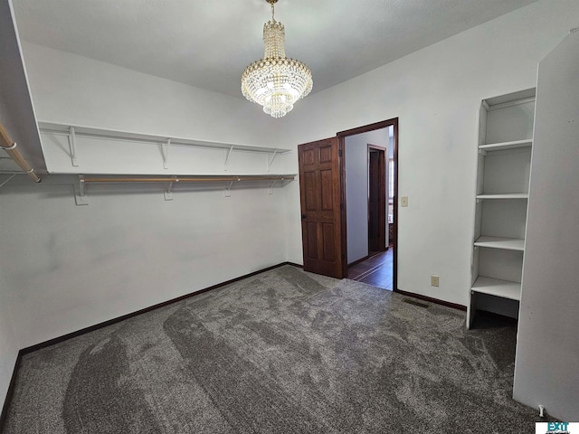 spacious closet with dark carpet