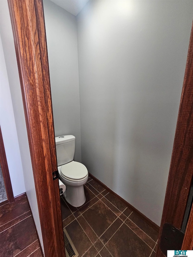 bathroom featuring toilet and tile patterned flooring