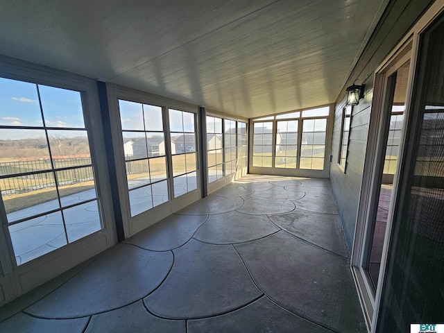 unfurnished sunroom with lofted ceiling