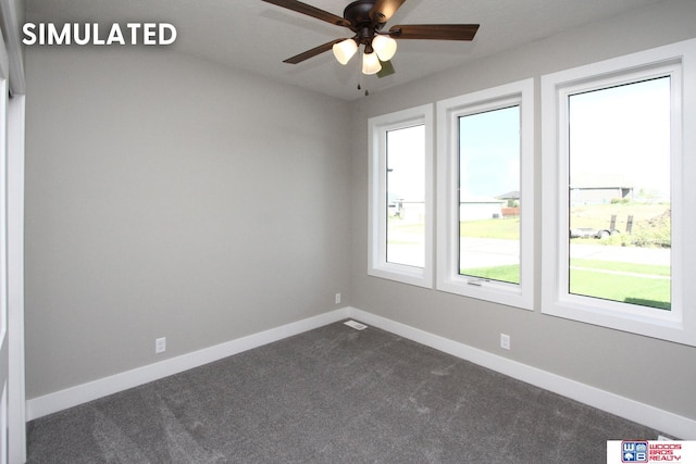 unfurnished room featuring ceiling fan and dark carpet