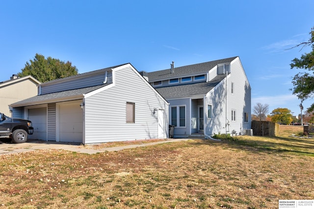 view of front of property with a garage and a front lawn