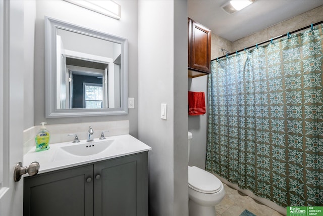 bathroom featuring toilet, vanity, and a shower with shower curtain