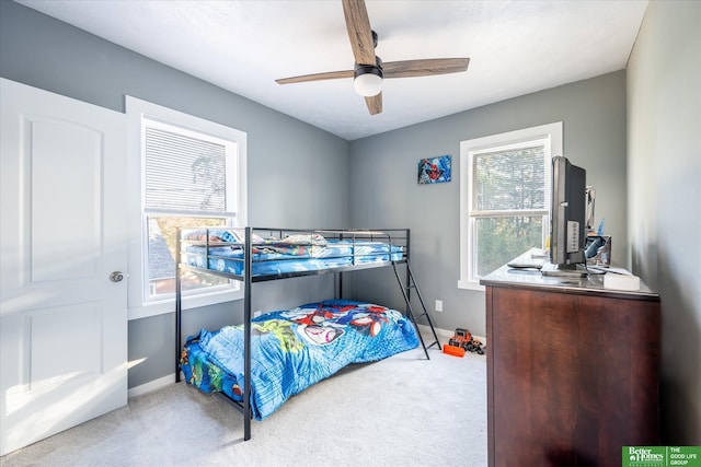 bedroom featuring carpet, multiple windows, and ceiling fan