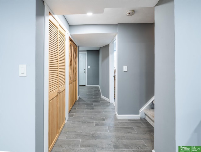 corridor with hardwood / wood-style floors