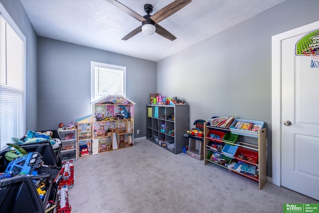 recreation room with light colored carpet and ceiling fan