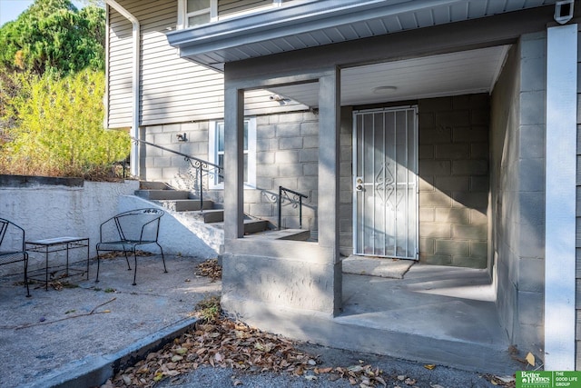 view of exterior entry with a patio