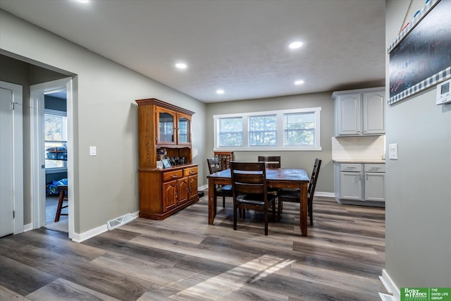 dining room with dark hardwood / wood-style flooring