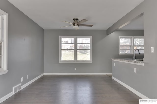 unfurnished room with sink, ceiling fan, and dark hardwood / wood-style flooring