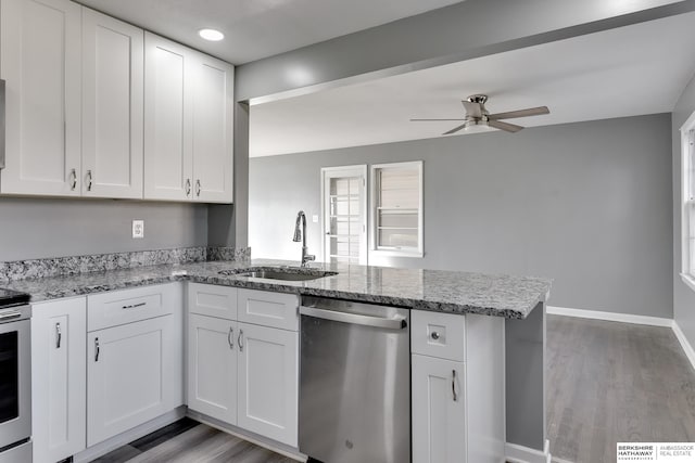 kitchen featuring appliances with stainless steel finishes, white cabinetry, and sink