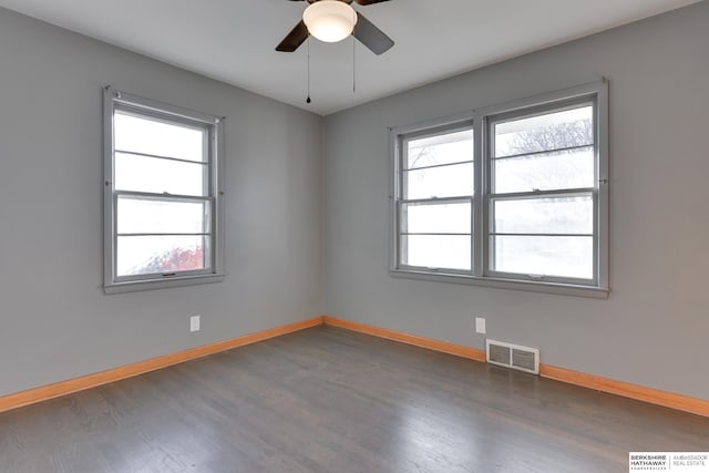 spare room with dark hardwood / wood-style floors and ceiling fan