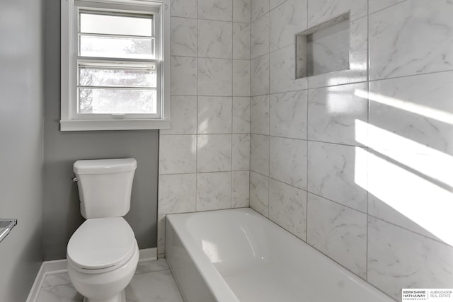 bathroom with toilet and a tub