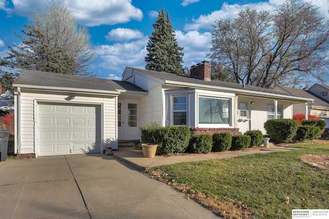 ranch-style home featuring a front yard and a garage