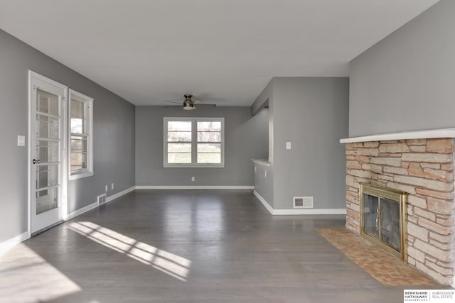 unfurnished living room with dark wood-type flooring, a fireplace, and ceiling fan