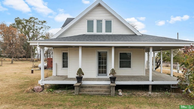 rear view of property with a lawn