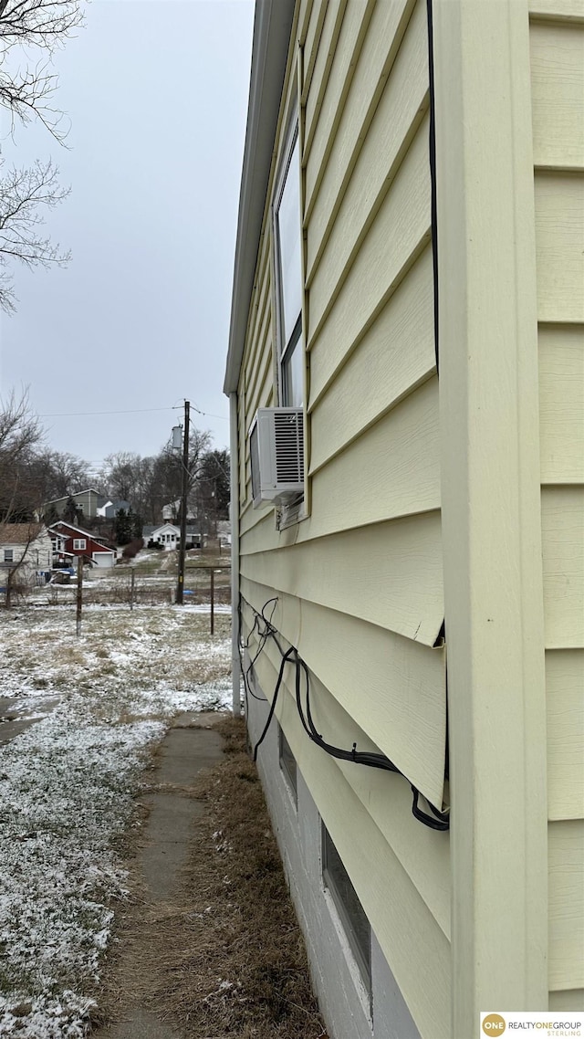 view of snowy exterior with cooling unit