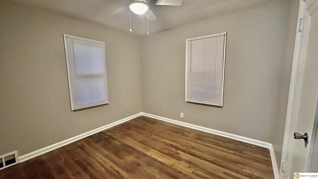 unfurnished room with ceiling fan and dark hardwood / wood-style flooring