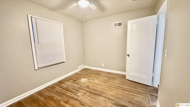 unfurnished room with wood-type flooring and ceiling fan